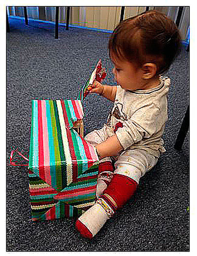 A child opening up a present at Make it Take it